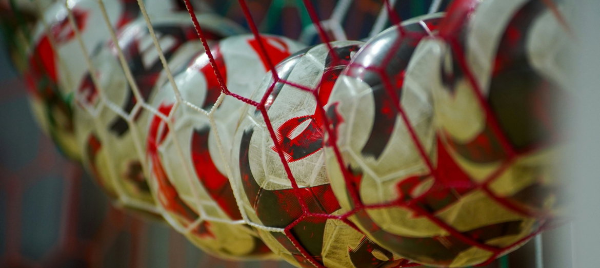 a close up of a soccer ball in a net